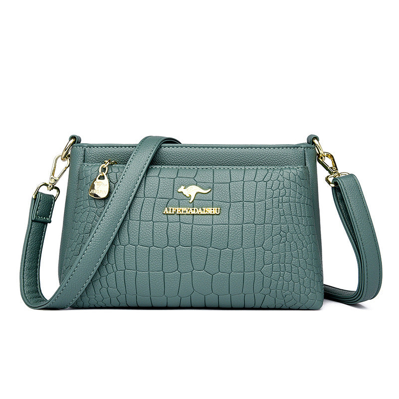 Green textured crossbody purse for every occasion with adjustable strap and gold accents