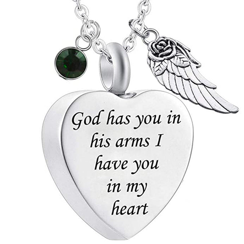 Heart-shaped Wing Urn cremation jewelry pendant with engraved message and decorative charms by Sheila Merchandise