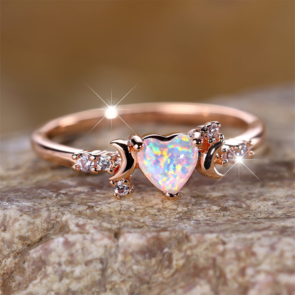 Rose gold moonstone love ring with heart shaped opal and three claw setting on both sides