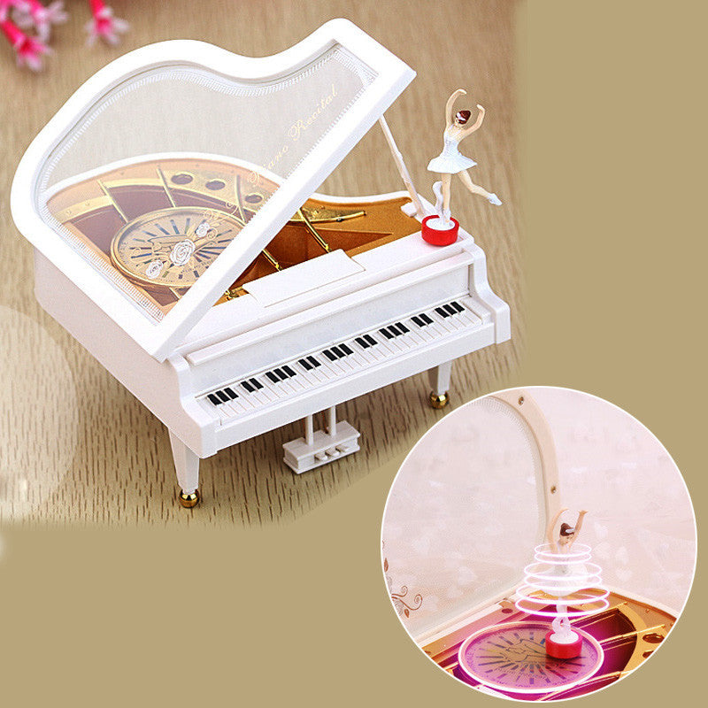 White musical ballet dancer box shaped like a grand piano with a ballerina figure and rotating light-up feature