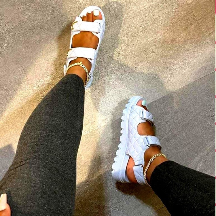 White quilted platform sandals for every occasion worn with gold anklets and black leggings