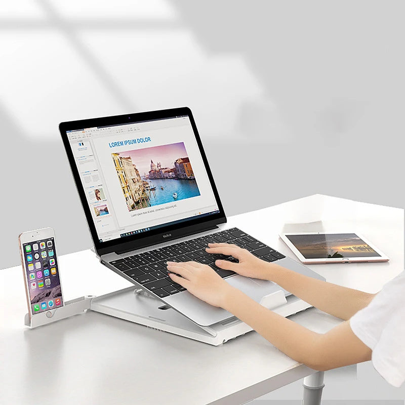 Portable laptop stand aluminum elevating a laptop for ergonomic use on a desk