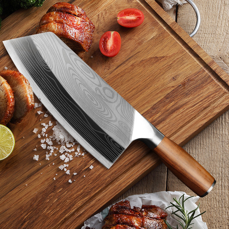 Premium stainless steel kitchen knife with wooden handle on wooden cutting board with sliced meat and tomatoes