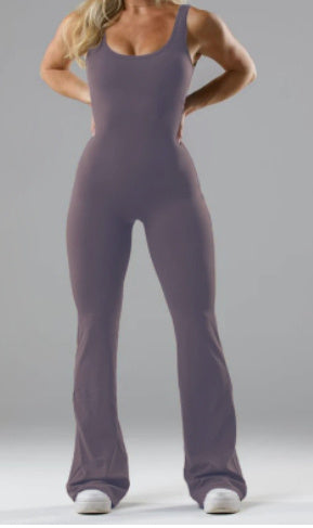 Women wearing a purple slim fit jumpsuit for women with a sleeveless design and flared legs