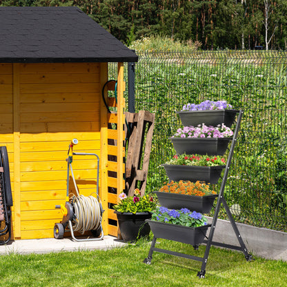 Sheila Merchandise stackable garden beds displayed beside a garden shed with colorful flowers.