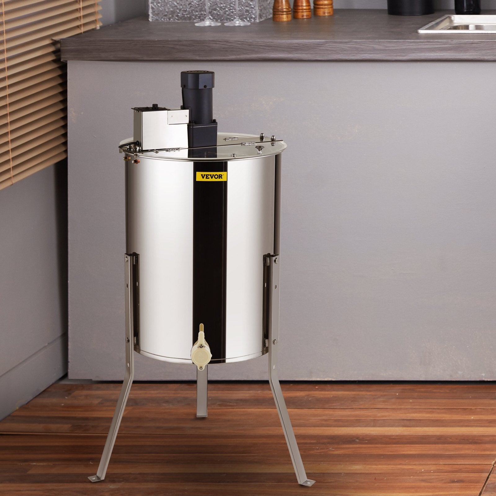 Stainless steel honey extractor by Sheila Merchandise with sturdy legs and motorized spinner for efficient honey harvesting