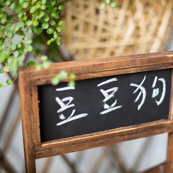 Wooden framed garden decoration planter with black chalkboard and green hanging plant
