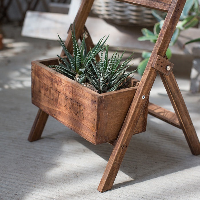 Wooden garden decoration planter with green succulent plants on rustic stand by Sheila Merchandise